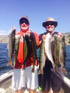 Dave Montelius and Jon Hermes hold up some Holter lake trout.