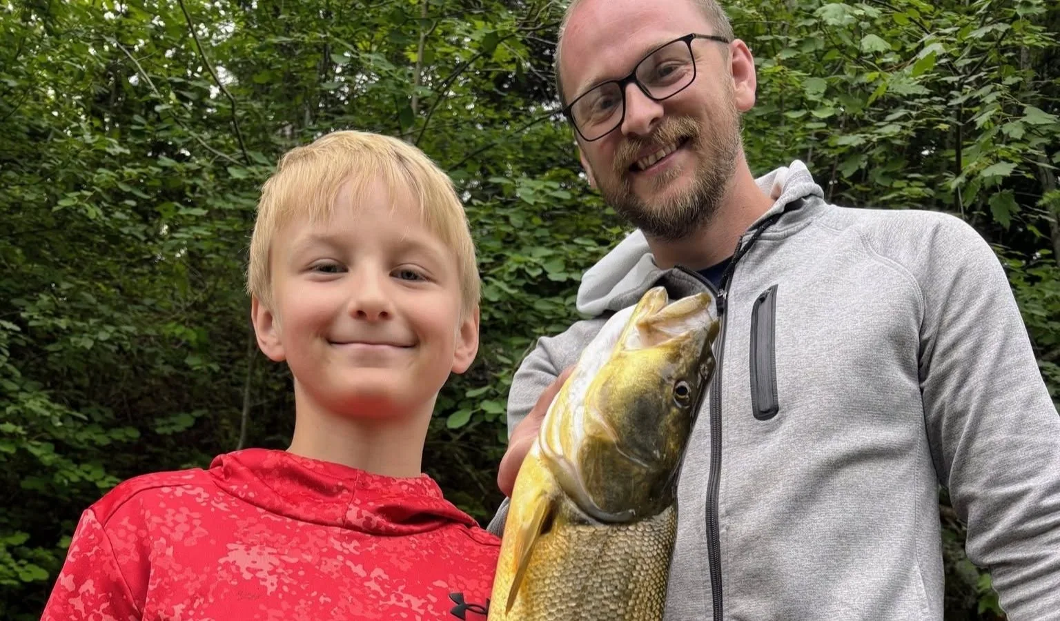 Young Angler Catches Rainbow Trout and Record-Sized Pikeminnow